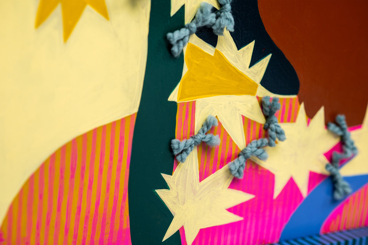 Detail of Crazy Girl by Sydney Noland: an angled view of raised yarn ties on yellow stars over pink stripes and dark green